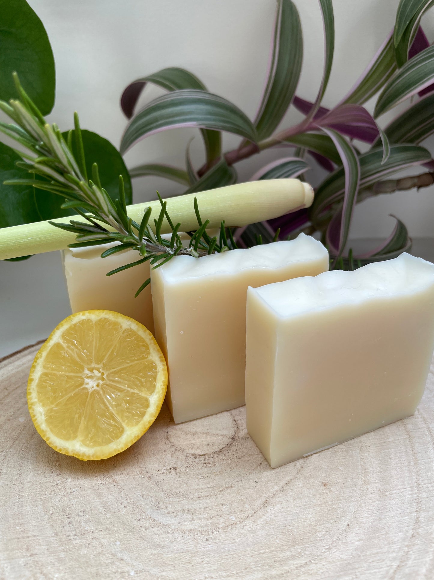 Environmentally friendly handmade lavender, lemongrass & rosemary soap bars, scented and displayed with lavender, lemongrass and a sprig of rosemary.