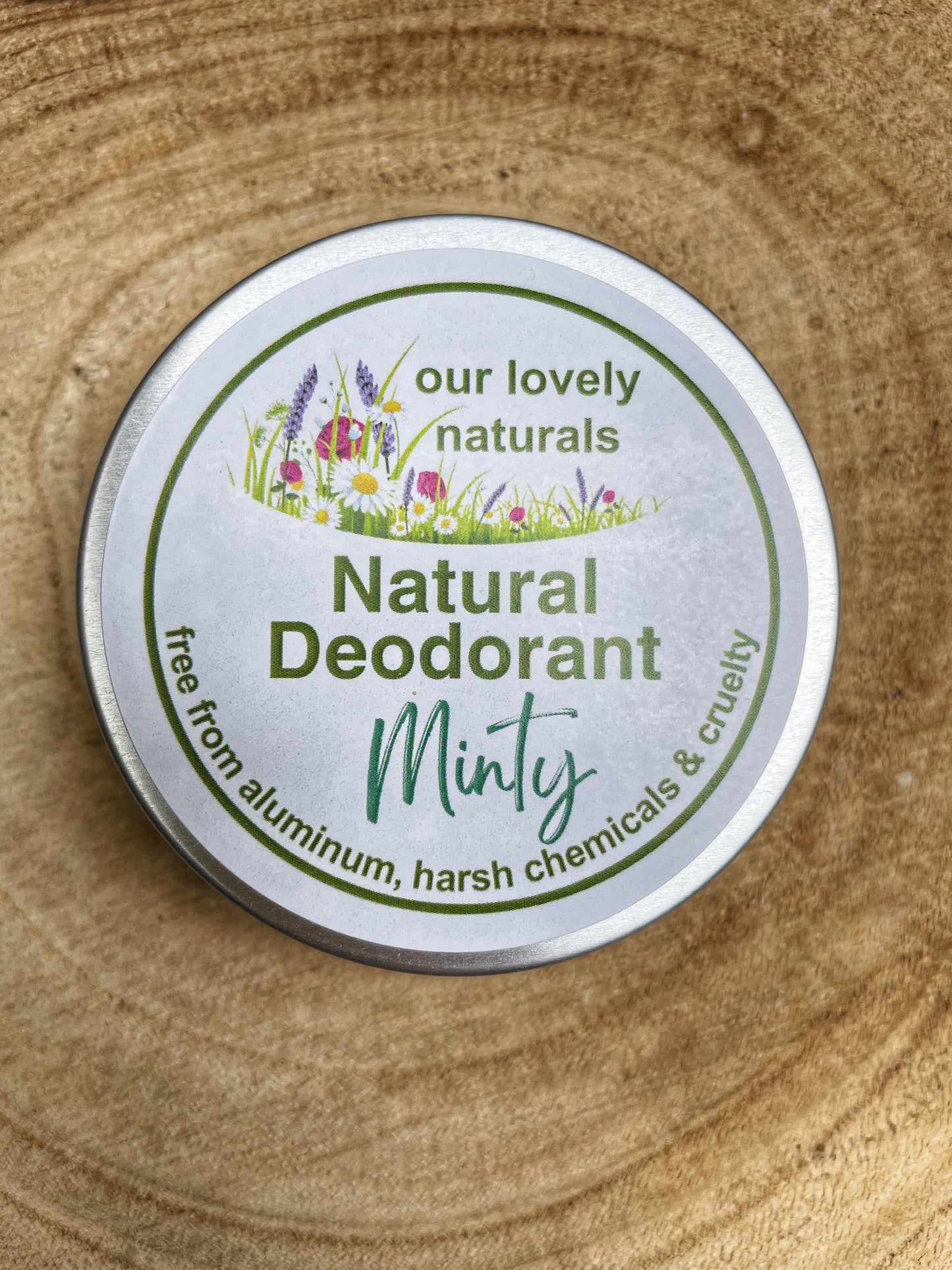 Tin of handmade, sustainable, plastic free, minty natural deodorant on a wooden board